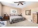 Bedroom with king-size bed, ceiling fan, and large mirror at 42621 W Heavenly Pl, Maricopa, AZ 85138