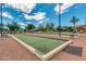 Well-maintained bocce ball courts in a sunny community setting at 42621 W Heavenly Pl, Maricopa, AZ 85138