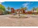 Elegant community center with a fountain and palm trees at 42621 W Heavenly Pl, Maricopa, AZ 85138