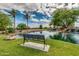 Serene lake with a bench and beautiful landscaping at 42621 W Heavenly Pl, Maricopa, AZ 85138