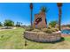 Community entrance sign with landscaping and pond feature at 42621 W Heavenly Pl, Maricopa, AZ 85138