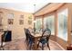 Bright dining area with a wooden table and four chairs at 42621 W Heavenly Pl, Maricopa, AZ 85138