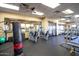 Well-equipped fitness center with weight machines, cardio equipment, and a punching bag at 42621 W Heavenly Pl, Maricopa, AZ 85138