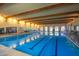 Indoor lap pool with ample space for swimming at 42621 W Heavenly Pl, Maricopa, AZ 85138