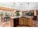 Large kitchen with granite island and views to backyard at 42621 W Heavenly Pl, Maricopa, AZ 85138