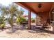 Covered patio overlooking the lake with seating at 42621 W Heavenly Pl, Maricopa, AZ 85138