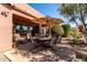 Covered patio with seating area and brick pavers at 42621 W Heavenly Pl, Maricopa, AZ 85138