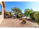 Relaxing patio with lake view, umbrella, and seating at 42621 W Heavenly Pl, Maricopa, AZ 85138