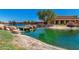 Peaceful pond with a bridge and walking path at 42621 W Heavenly Pl, Maricopa, AZ 85138