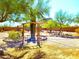 Expansive backyard with a decorative archway, desert landscaping, and mature trees at 44311 N 1St Dr, New River, AZ 85087