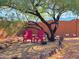 Relaxing backyard patio area with two red chairs under a tree at 44311 N 1St Dr, New River, AZ 85087