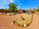 Landscaped backyard with rock garden and detached garage at 44311 N 1St Dr, New River, AZ 85087