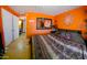 Bedroom with orange walls and patterned bedspread at 44311 N 1St Dr, New River, AZ 85087