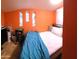 Small bedroom with orange walls and stained glass windows at 44311 N 1St Dr, New River, AZ 85087