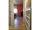 Bedroom with tiled floor, orange accent wall, and window with sheer curtain at 44311 N 1St Dr, New River, AZ 85087