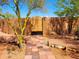 A private entry to a home through a stone archway and wooden door at 44311 N 1St Dr, New River, AZ 85087