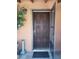 A front door with decorative woodwork stands ajar, beckoning visitors inside at 44311 N 1St Dr, New River, AZ 85087