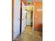 Hallway with tiled floor, a storage cabinet with drawers, and an open door at 44311 N 1St Dr, New River, AZ 85087