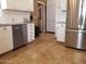 Kitchen with white cabinets, stainless steel appliances, and a door to the exterior at 44311 N 1St Dr, New River, AZ 85087