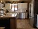 Bright, modern kitchen features stainless steel appliances and white cabinetry at 44311 N 1St Dr, New River, AZ 85087