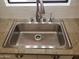 A close up of the stainless steel kitchen sink and faucet at 44311 N 1St Dr, New River, AZ 85087