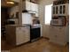 Bright kitchen with white cabinetry, granite countertops, and stainless steel oven at 44311 N 1St Dr, New River, AZ 85087