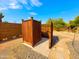 Private outdoor shower featuring a wooden structure with a stone tile base and gravel surround at 44311 N 1St Dr, New River, AZ 85087