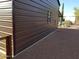 Exterior view of the brown storage shed with a window and cactus landscaping at 44311 N 1St Dr, New River, AZ 85087