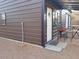 Exterior of the storage shed with a small covered patio area and a seating set at 44311 N 1St Dr, New River, AZ 85087