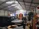 Interior of metal storage shed with jeep, surfboard, and materials neatly stacked at 44311 N 1St Dr, New River, AZ 85087