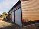 Close up of the exterior of the brown and grey storage shed with a large door at 44311 N 1St Dr, New River, AZ 85087