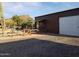 Exterior of the shed with fenced yard, desert landscape, and mountain views at 44311 N 1St Dr, New River, AZ 85087