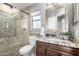 Bathroom with granite countertop, walk-in shower, and pebble tile at 4849 E Abraham Ln, Phoenix, AZ 85054