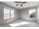 Bright bedroom with ceiling fan and large windows at 4849 E Abraham Ln, Phoenix, AZ 85054