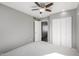 Spacious bedroom with double door closet and ceiling fan at 4849 E Abraham Ln, Phoenix, AZ 85054