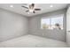 Well-lit bedroom featuring a ceiling fan and window at 4849 E Abraham Ln, Phoenix, AZ 85054