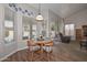 Bright breakfast nook with wood floors, round table, and views of the pool at 5184 W Del Rio St, Chandler, AZ 85226