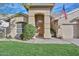 Inviting front entrance featuring a decorative wood door, manicured lawn, and tiled roof at 5184 W Del Rio St, Chandler, AZ 85226