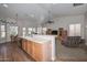 Open kitchen with island, laminate counters, oak cabinets, and connection to the living space at 5184 W Del Rio St, Chandler, AZ 85226