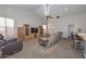 Spacious living room featuring built-in shelving, neutral carpet, and ceiling fan at 5184 W Del Rio St, Chandler, AZ 85226