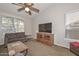 Comfortable living room with carpet, neutral walls, ceiling fan and plenty of natural light at 5184 W Del Rio St, Chandler, AZ 85226