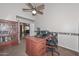 Comfortable home office with built-in bookcase and ceiling fan at 5184 W Del Rio St, Chandler, AZ 85226