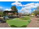 Expansive backyard with putting green, covered patio, and plenty of space for entertaining at 5213 W Soft Wind Dr, Glendale, AZ 85310