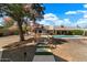 Relaxing backyard with a refreshing pool and a stone pathway leading to the house at 5213 W Soft Wind Dr, Glendale, AZ 85310