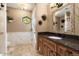 Bathroom with dark vanity, tile flooring and window at 5213 W Soft Wind Dr, Glendale, AZ 85310