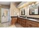 Elegant bathroom with double vanity, granite countertops, and large mirrors at 5213 W Soft Wind Dr, Glendale, AZ 85310