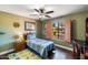 Bedroom with wood flooring, window shutters, and ceiling fan at 5213 W Soft Wind Dr, Glendale, AZ 85310