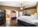 Bright bedroom with hardwood floors, ceiling fan, and ensuite bathroom at 5213 W Soft Wind Dr, Glendale, AZ 85310