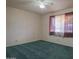 Spacious bedroom with green carpet and window coverings at 5720 E Cicero St, Mesa, AZ 85205