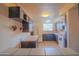 Galley kitchen with dark wood cabinets and appliances at 5720 E Cicero St, Mesa, AZ 85205